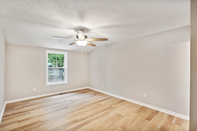 empty room featuring ceiling fan, a textured ceiling, and light hardwood / wood-style floors