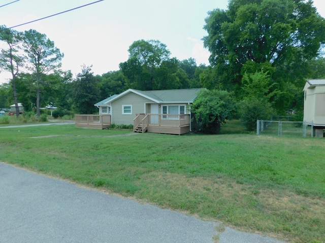 view of side of home featuring a lawn and a deck