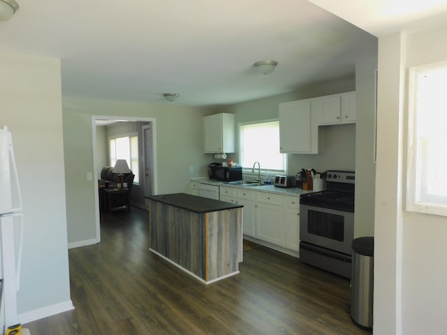 kitchen with dark wood-type flooring, white cabinets, stainless steel range with electric stovetop, white dishwasher, and sink