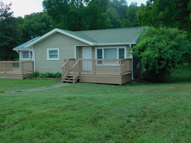 view of front facade with a front lawn and a wooden deck