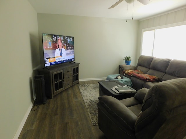 living room featuring dark wood-type flooring and ceiling fan