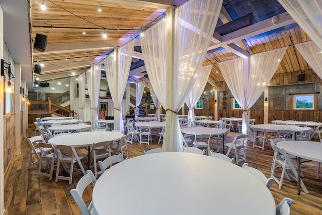 dining area with wood ceiling, high vaulted ceiling, wood walls, beam ceiling, and hardwood / wood-style flooring