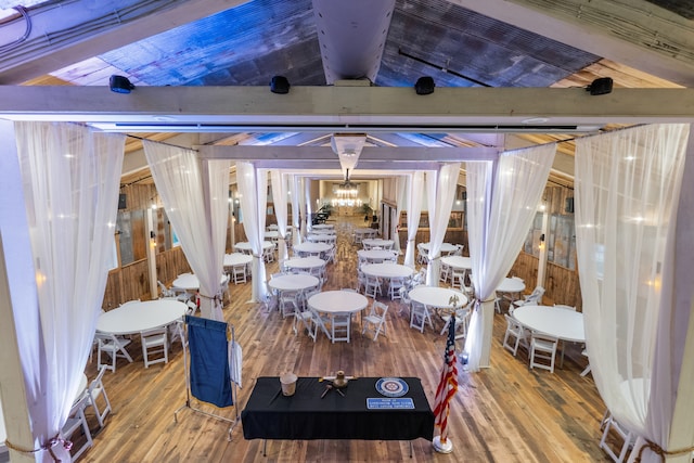 interior space with lofted ceiling with beams and hardwood / wood-style flooring