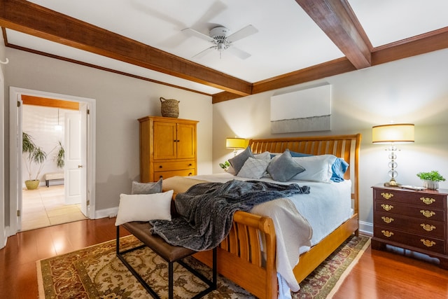 bedroom featuring beam ceiling, hardwood / wood-style floors, and ceiling fan