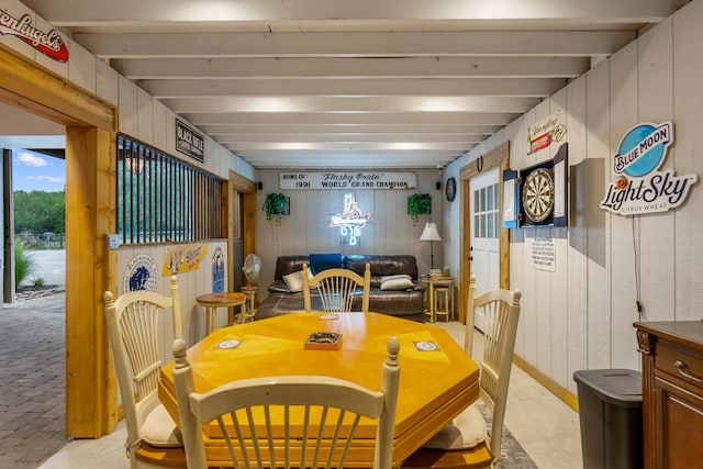 dining room with wood walls