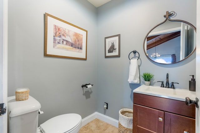 bathroom featuring vanity, tile patterned flooring, and toilet