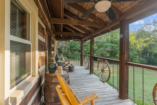 deck with a lawn and ceiling fan