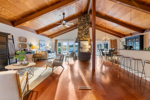 living room featuring wood ceiling, beamed ceiling, hardwood / wood-style flooring, ceiling fan with notable chandelier, and french doors