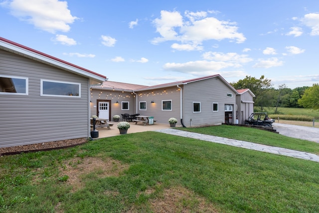 rear view of house featuring a yard and a patio area