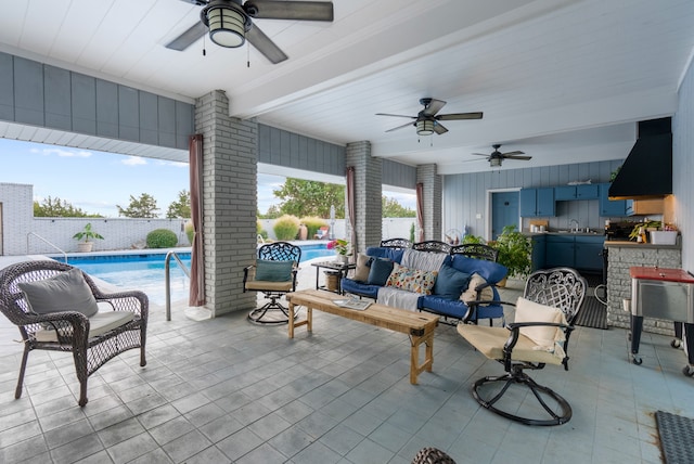 view of patio / terrace featuring a fenced in pool, ceiling fan, and sink