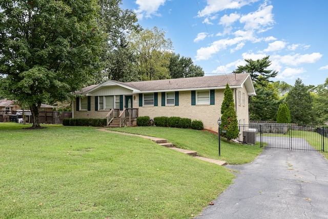 ranch-style home with central AC and a front lawn