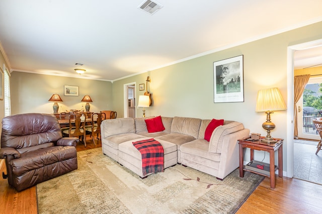 living room featuring ornamental molding and hardwood / wood-style flooring