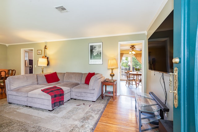 living room with ceiling fan, wood-type flooring, and ornamental molding