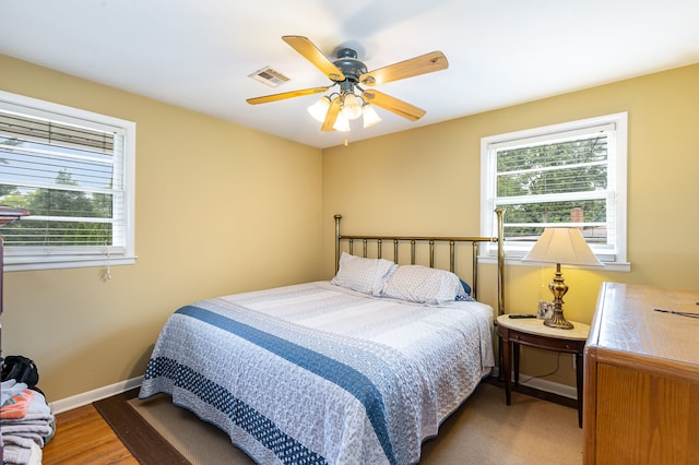 bedroom with hardwood / wood-style floors and ceiling fan