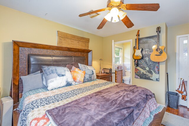 bedroom with ensuite bath, wood-type flooring, and ceiling fan