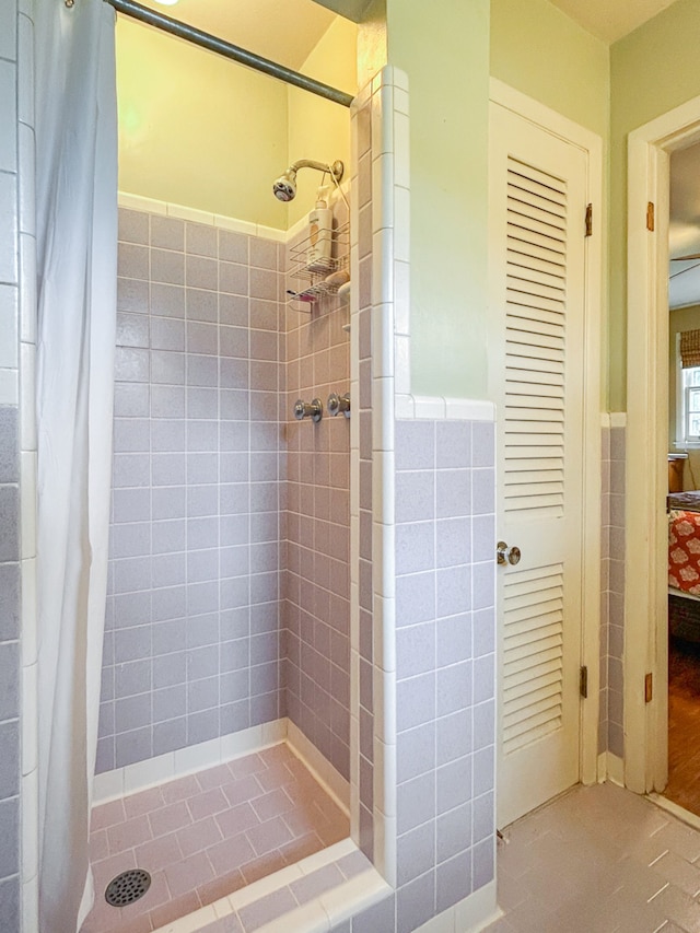 bathroom with walk in shower and tile walls