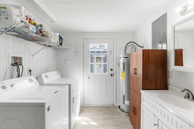 laundry area featuring wooden walls, water heater, washer and clothes dryer, and sink