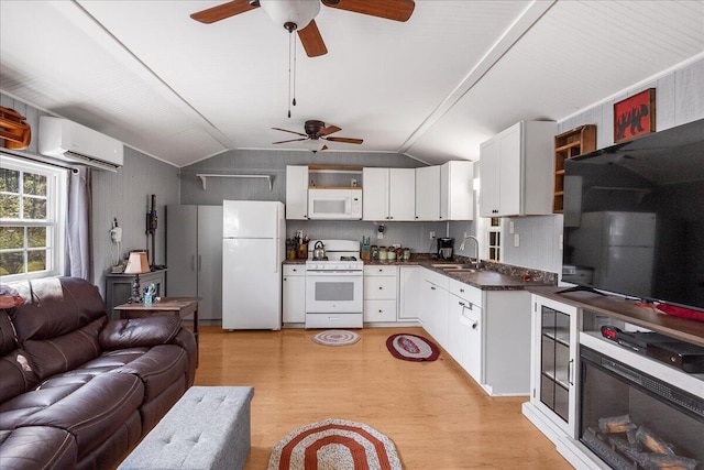 kitchen featuring lofted ceiling, white appliances, ceiling fan, and a wall unit AC