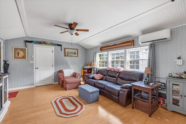 living room featuring lofted ceiling, light hardwood / wood-style floors, ceiling fan, and a wall mounted air conditioner