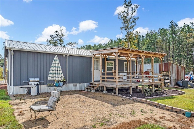 back of property featuring a pergola