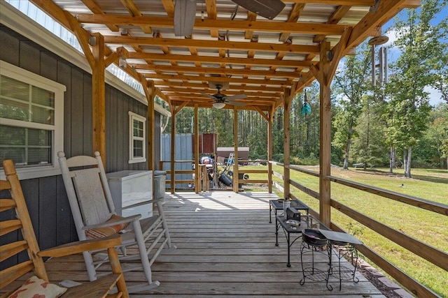 wooden terrace with a lawn and ceiling fan