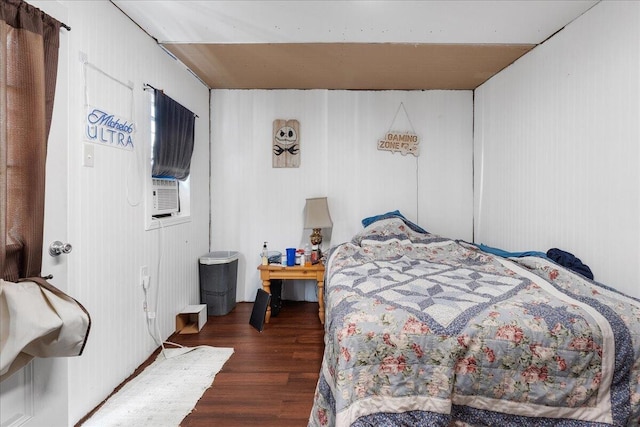 bedroom with dark hardwood / wood-style floors