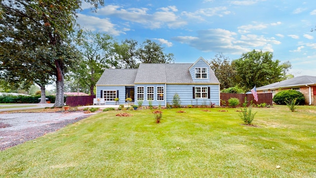 cape cod-style house with a front yard