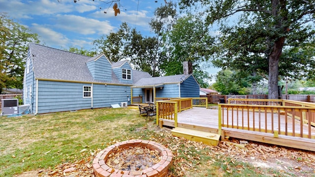 exterior space with a lawn, an outdoor fire pit, and a deck