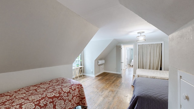 bedroom featuring vaulted ceiling and hardwood / wood-style floors