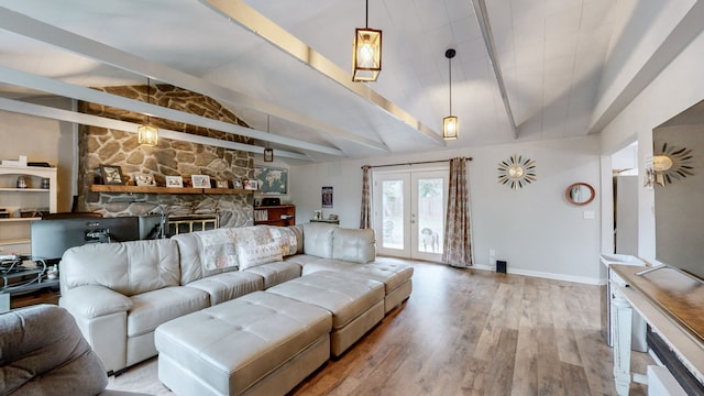 living room with vaulted ceiling with beams, a stone fireplace, wood-type flooring, and french doors