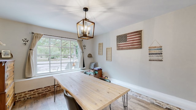 dining space featuring light wood-type flooring and a chandelier