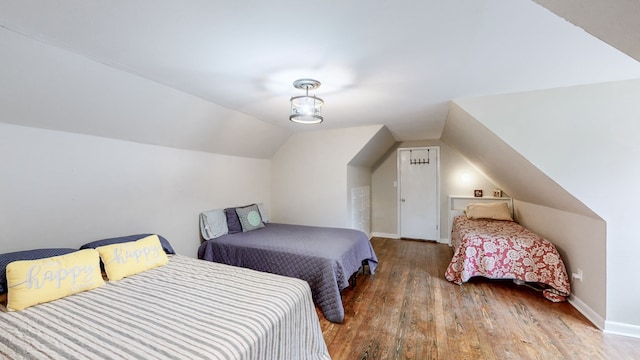 bedroom featuring lofted ceiling and hardwood / wood-style flooring