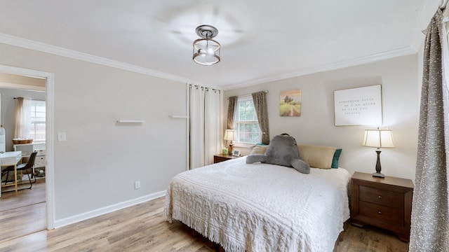 bedroom with multiple windows, wood-type flooring, and ornamental molding