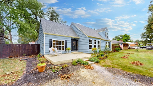 rear view of property with a patio area and a yard