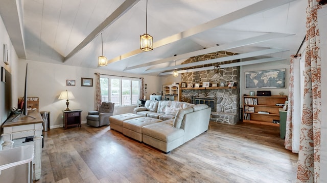 living room with vaulted ceiling with beams, hardwood / wood-style floors, and a fireplace