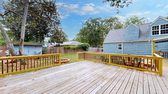 wooden deck featuring a storage shed