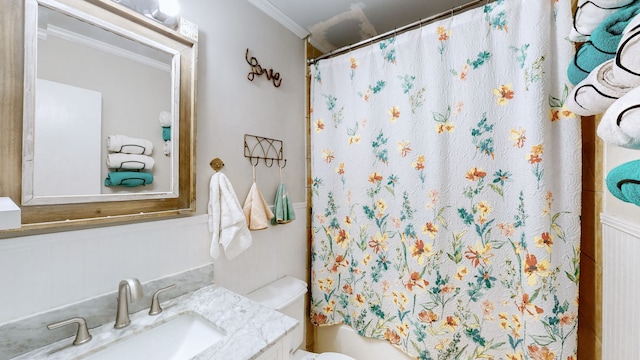 bathroom with ornamental molding, a shower with curtain, vanity, and toilet