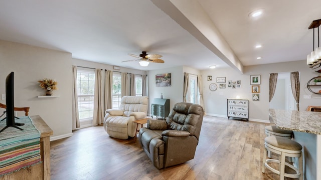 living room featuring light wood-type flooring and ceiling fan