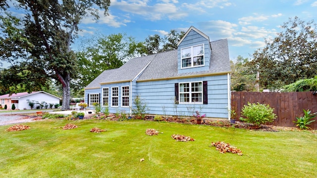 new england style home with a front lawn