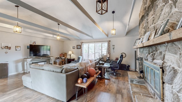 living room featuring hardwood / wood-style flooring, a fireplace, and lofted ceiling with beams