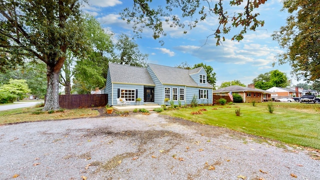 cape cod house with a front lawn