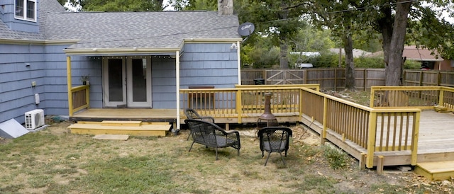 wooden terrace featuring a yard and ac unit