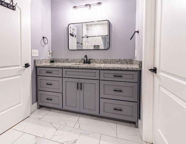 bathroom featuring walk in shower and vanity