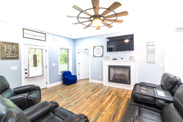 living room featuring hardwood / wood-style floors and ceiling fan