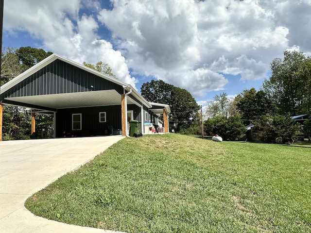 view of home's exterior with a lawn and a carport