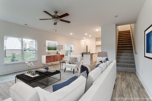 living room featuring light hardwood / wood-style floors, sink, and ceiling fan