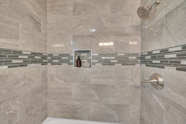 bathroom with a tile shower