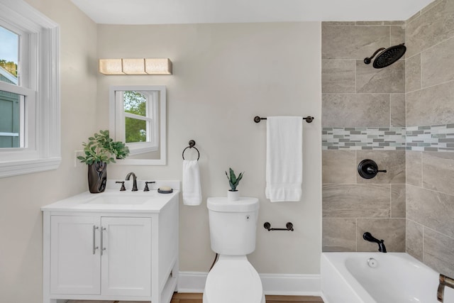 full bathroom with a wealth of natural light, vanity, and toilet