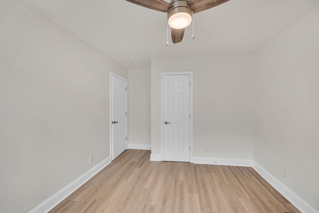 empty room with light wood-type flooring and ceiling fan