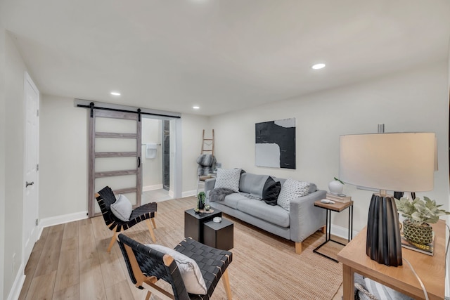 living room with light hardwood / wood-style flooring and a barn door